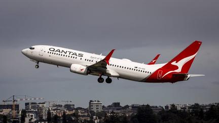 Qantas cuts flights, raises fares
